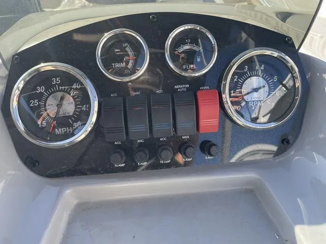 Slide: The Image of Dashboard of 2023 Lowe Ultra 182 Fish & Cruise boat with gauges and switches. - 18