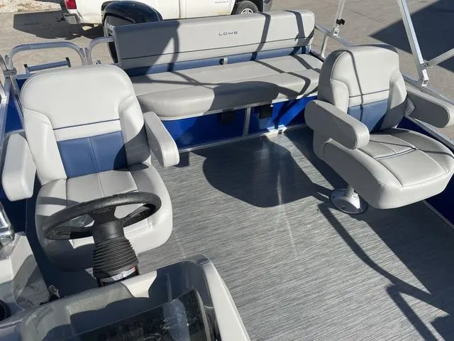 Slide: The Image of 2023 Lowe Ultra 182 Fish & Cruise boat interior with seating and steering wheel. - 20
