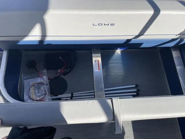 Slide: The Image of 2023 Lowe Ultra 182 Fish & Cruise boat storage compartment with accessories. - 22