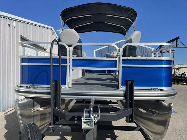 Slide: The Image of 2023 Lowe Ultra 182 Fish & Cruise pontoon boat, blue exterior, parked outdoors. - 7
