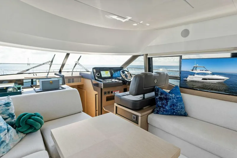 Slide: The Image of Luxurious interior of 2023 Prestige 460 Flybridge yacht with modern helm and seating. - 12