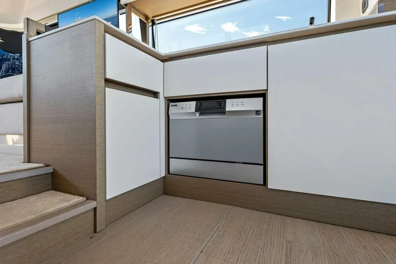 Slide: The Image of Modern kitchen area in 2023 Prestige 460 Flybridge yacht, featuring sleek cabinetry and built-in appliances. - 14