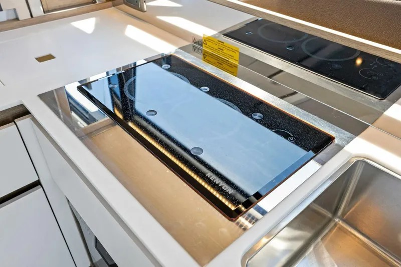 Slide: The Image of Modern kitchen on 2023 Prestige 460 Flybridge yacht with sleek stovetop and sink. - 15