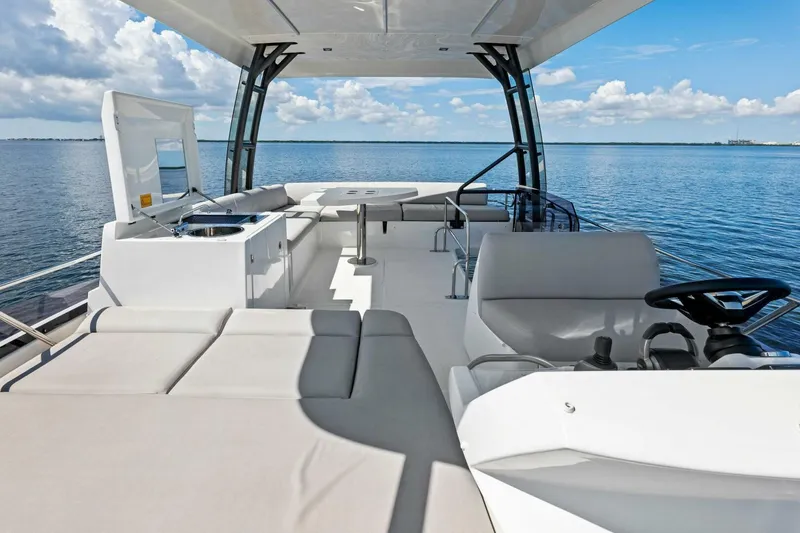 Slide: The Image of 2023 Prestige 460 Flybridge yacht interior with luxurious seating and ocean view. - 2