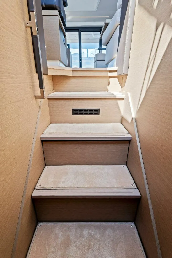 Slide: The Image of Interior stairs of 2023 Prestige 460 Flybridge yacht, featuring modern design and wood finish. - 20