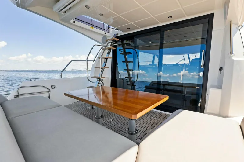 Slide: The Image of Prestige 460 Flybridge 2023 yacht with elegant outdoor seating and ocean view. - 45