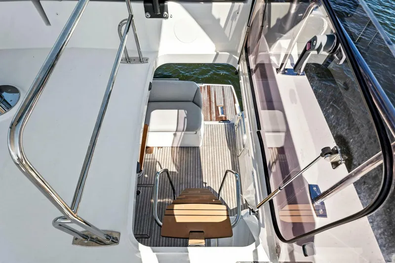 Slide: The Image of Prestige 460 Flybridge 2023 yacht interior with wooden stairs and seating area. - 48