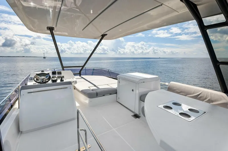 Slide: The Image of 2023 Prestige 460 Flybridge yacht with spacious deck and ocean view. - 49