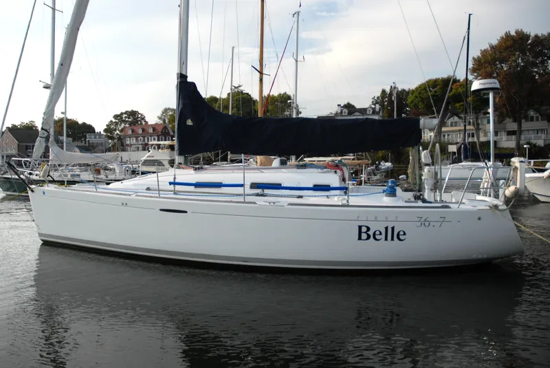 Slide: The Image of 2003 Beneteau 36.7 sailboat named "Belle" docked in a marina. - 0