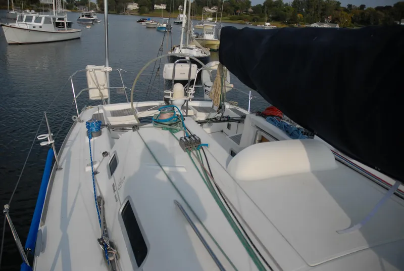 Slide: The Image of 2003 Beneteau 36.7 sailboat deck view with rigging and moored boats in background. - 10