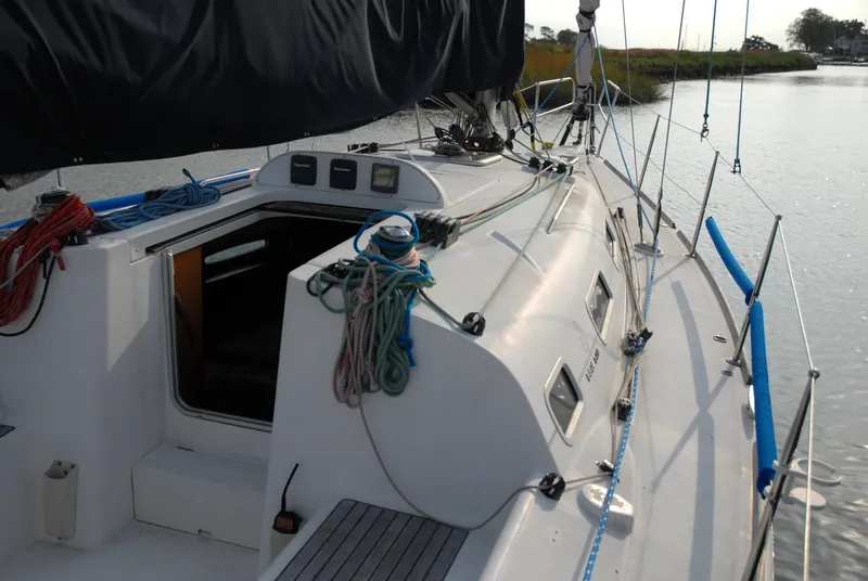 Slide: The Image of 2003 Beneteau 36.7 sailboat deck with ropes and open cabin entrance. - 13