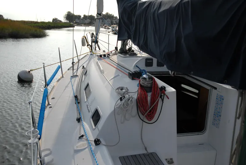 Slide: The Image of 2003 Beneteau 36.7 sailboat docked on a calm river. - 14