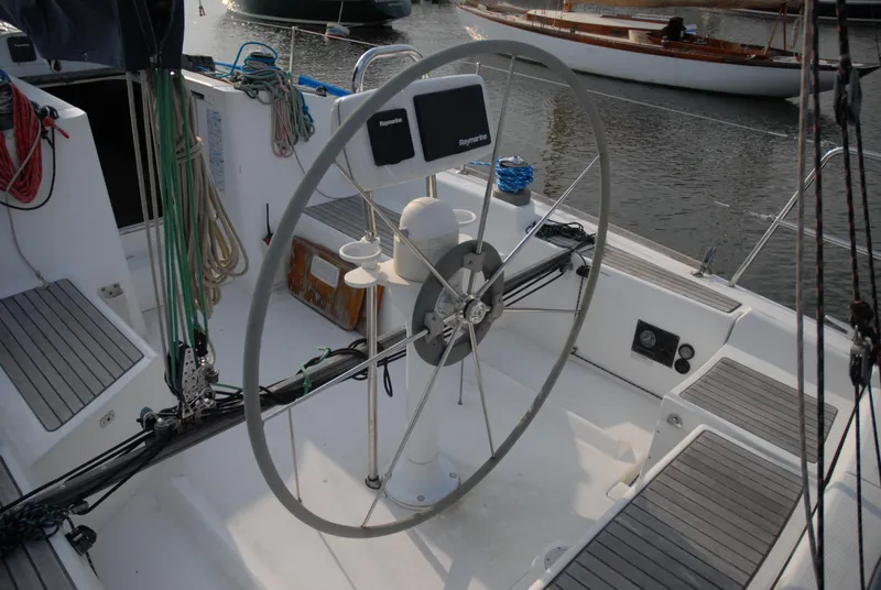 Slide: The Image of 2003 Beneteau 36.7 sailboat cockpit with steering wheel and navigation equipment. - 15