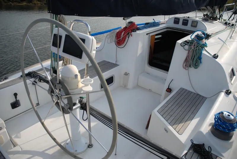 Slide: The Image of 2003 Beneteau 36.7 sailboat cockpit with steering wheel and ropes. - 17