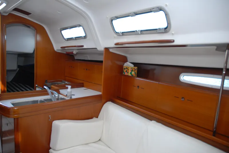 Slide: The Image of Interior of 2003 Beneteau 36.7 yacht with wood cabinetry and white seating. - 22