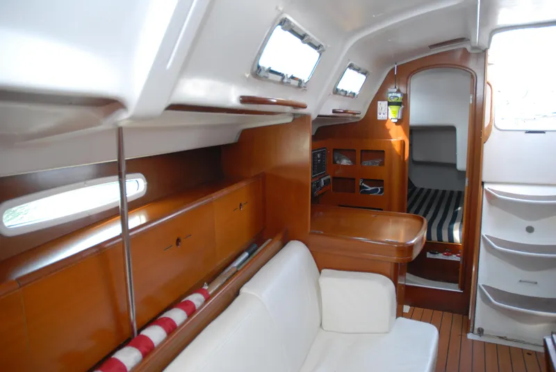 Slide: The Image of Interior of 2003 Beneteau 36.7 sailboat with wood finish and cozy seating area. - 23