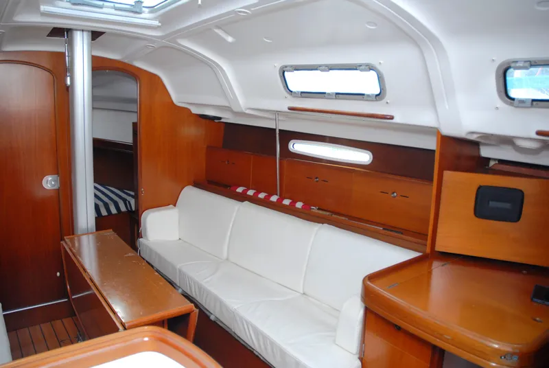 Slide: The Image of Interior of 2003 Beneteau 36.7 sailboat with wood finish and white seating. - 25