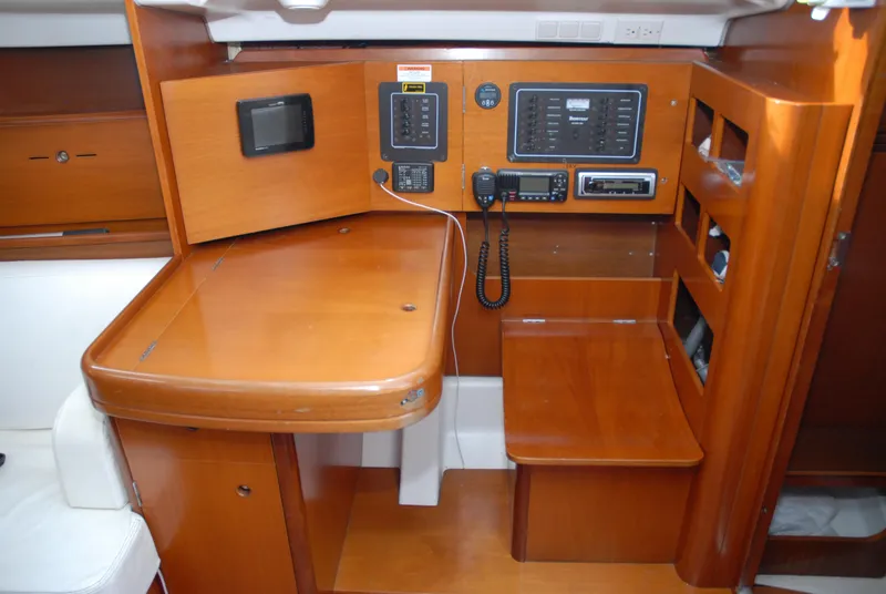 Slide: The Image of Interior of 2003 Beneteau 36.7 yacht with navigation station and wooden cabinetry. - 29
