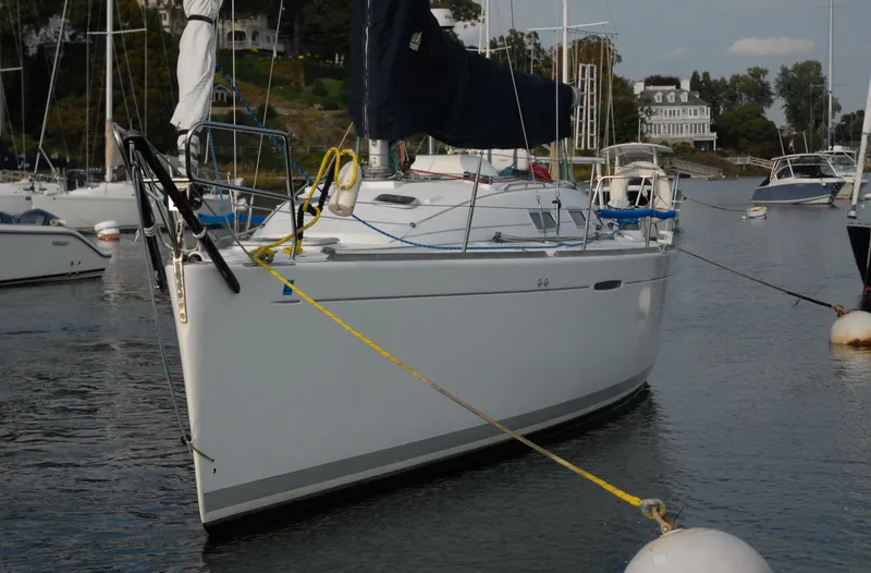 Slide: The Image of 2003 Beneteau 36.7 sailboat moored in a marina, calm waters, scenic background. - 3