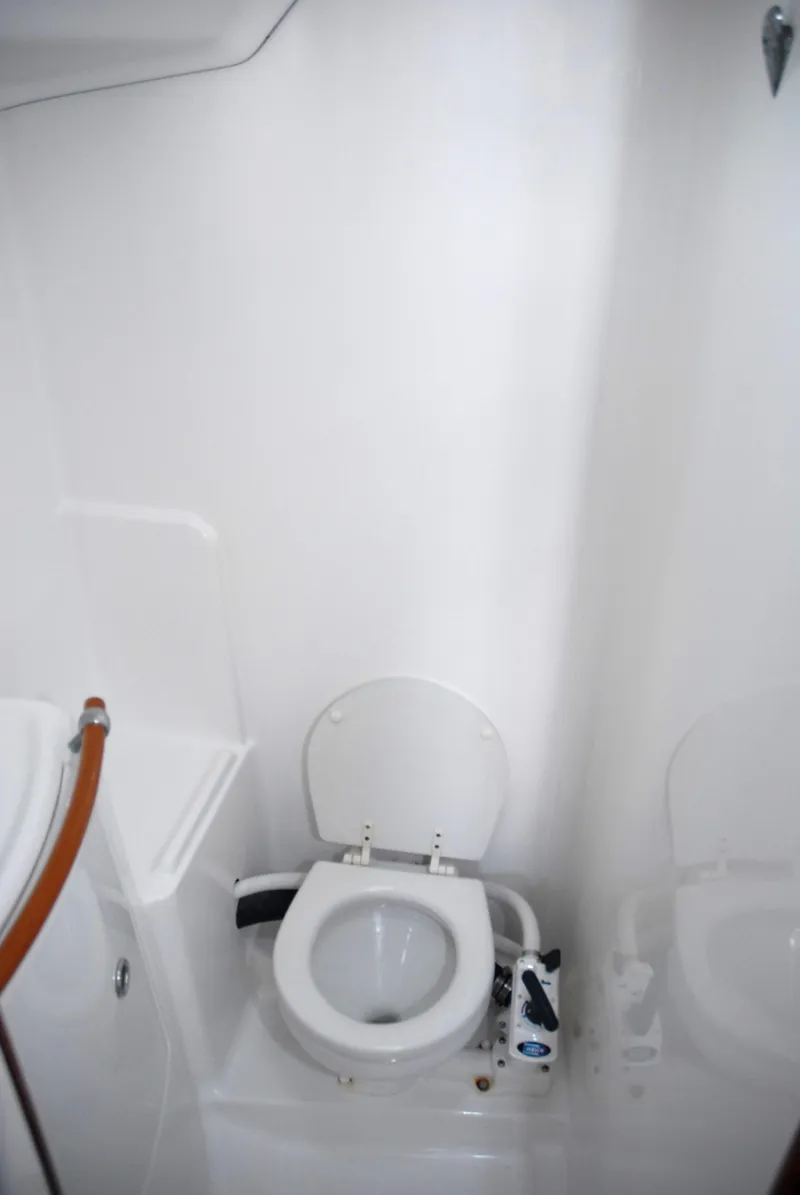 Slide: The Image of Beneteau 36.7 2003 yacht bathroom with white marine toilet. - 33