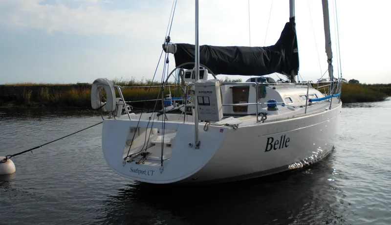 Slide: The Image of 2003 Beneteau 36.7 sailboat named "Belle" moored in calm waters. - 4