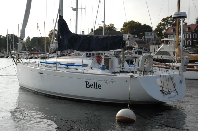 Slide: The Image of 2003 Beneteau 36.7 sailboat named "Belle" docked in a marina. - 7