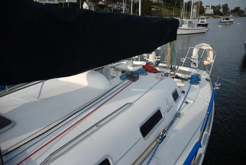 Slide: The Image of Beneteau 36.7 sailboat, 2003 model, docked in a marina with visible rigging and deck. - 8