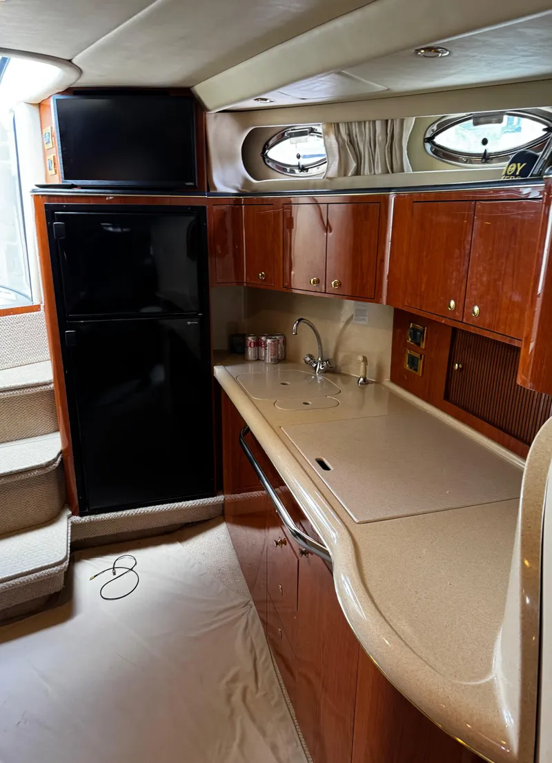 Slide: The Image of Luxurious 2001 Sea Ray 410 Sundancer yacht interior with modern kitchen amenities. - 15