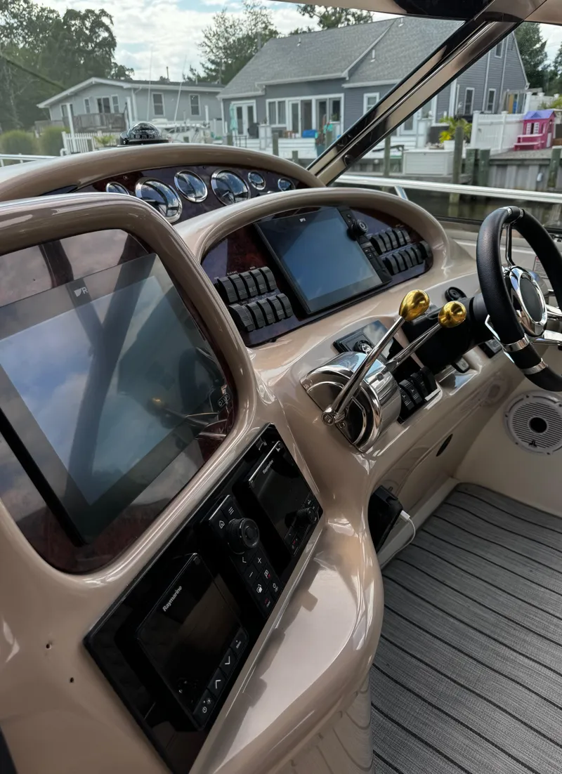 Slide: The Image of 2001 Sea Ray 410 Sundancer helm with modern navigation equipment and controls. - 16