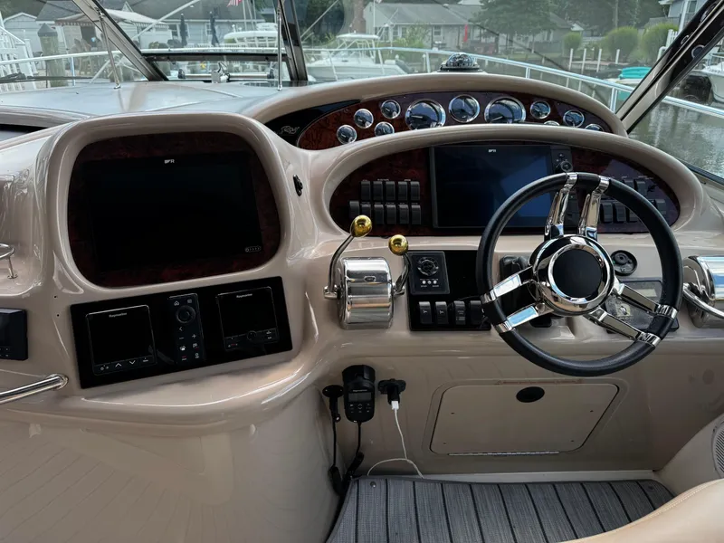 Slide: The Image of 2001 Sea Ray 410 Sundancer helm with modern controls and navigation displays. - 17