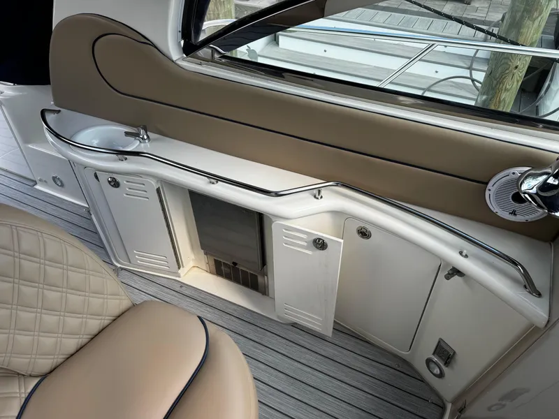 Slide: The Image of Interior of 2001 Sea Ray 410 Sundancer yacht with beige seating and cabinetry. - 18