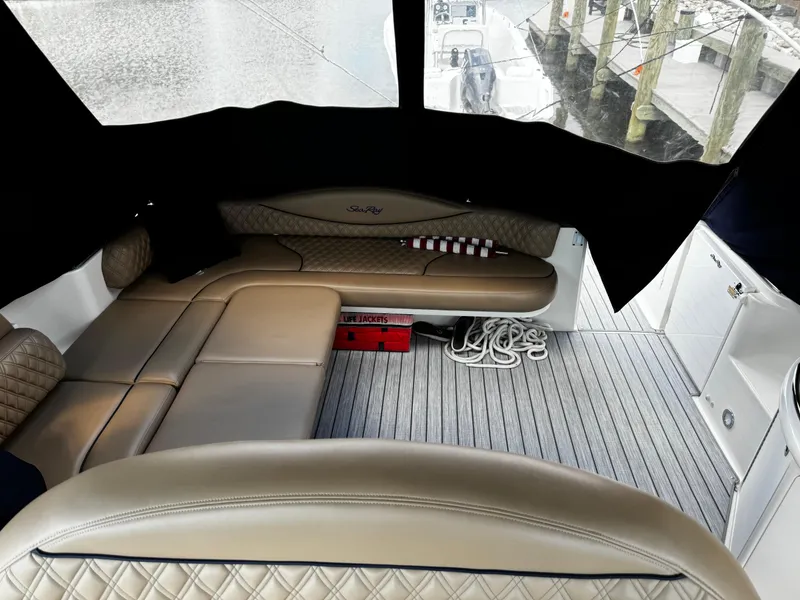 Slide: The Image of Interior of 2001 Sea Ray 410 Sundancer with beige seating and striped flooring. - 19