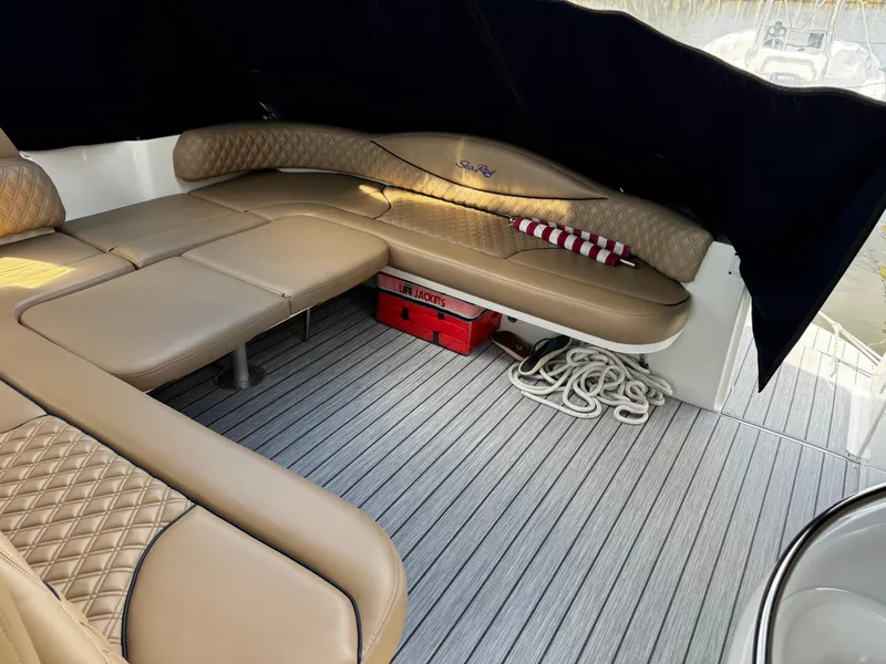 Slide: The Image of Luxurious interior of 2001 Sea Ray 410 Sundancer yacht with tan seating and striped pillow. - 22