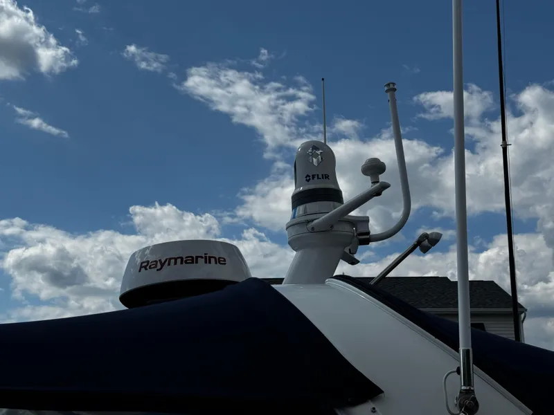 Slide: The Image of Radar equipment on 2001 Sea Ray 410 Sundancer against a cloudy sky. - 23