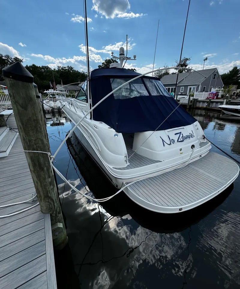Slide: The Image of 2001 Sea Ray 410 Sundancer docked at marina under blue sky. - 25