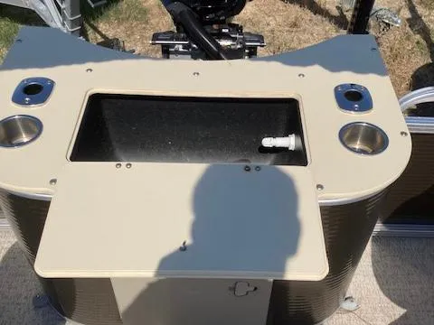 Slide: The Image of 2019 Tahoe Pontoon GT 2385 boat console with cup holders and storage compartment. - 10