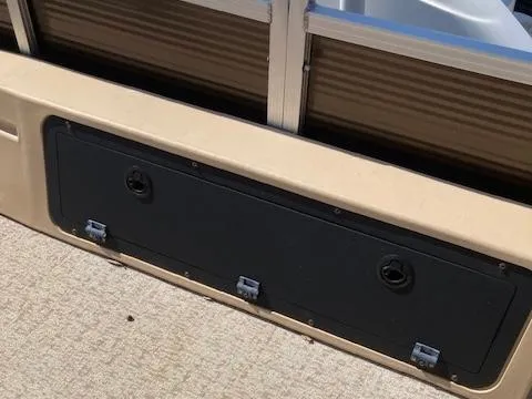 Slide: The Image of 2019 Tahoe Pontoon GT 2385 storage compartment on deck, beige and black design. - 11