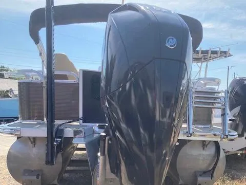 Slide: The Image of 2019 Tahoe Pontoon GT 2385 with powerful outboard motor, docked under clear sky. - 3