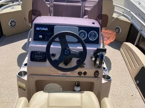 Slide: The Image of 2019 Tahoe Pontoon GT 2385 boat dashboard with steering wheel and controls. - 4