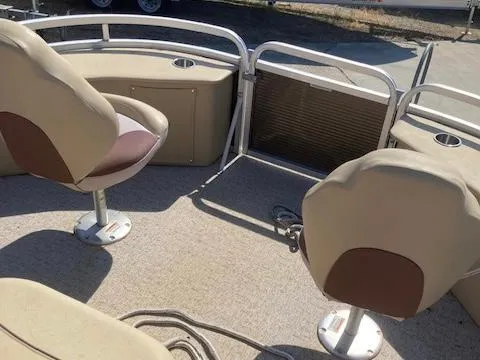 Slide: The Image of 2019 Tahoe Pontoon GT 2385 interior with beige seating and carpeted floor. - 6