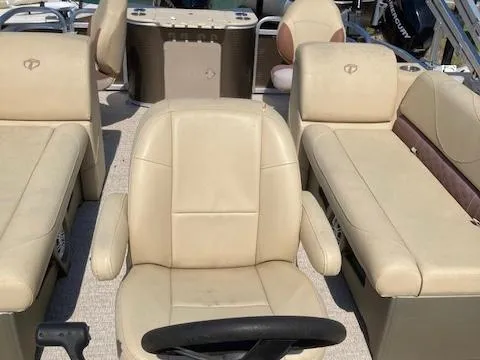 Slide: The Image of 2019 Tahoe Pontoon GT 2385 interior with beige seating and steering wheel. - 7