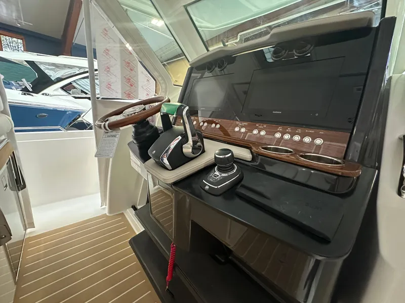 Slide: The Image of 2025 Tiara Yachts 34 LS helm with modern controls and sleek dashboard design. - 10