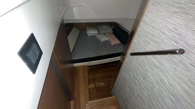 Slide: The Image of 2025 Tiara Yachts 34 LS cabin interior with bed and pillows. - 16