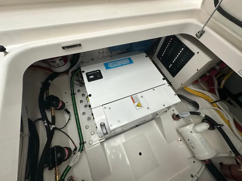 Slide: The Image of Engine compartment of 2025 Tiara Yachts 34 LS, showcasing electrical components and wiring. - 18