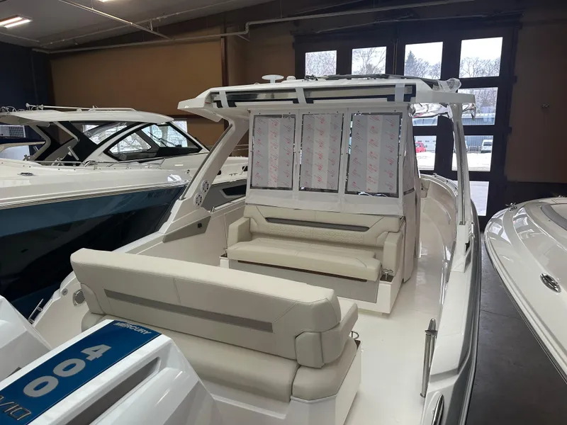 Slide: The Image of 2025 Tiara Yachts 34 LS luxury boat interior with seating in showroom. - 4