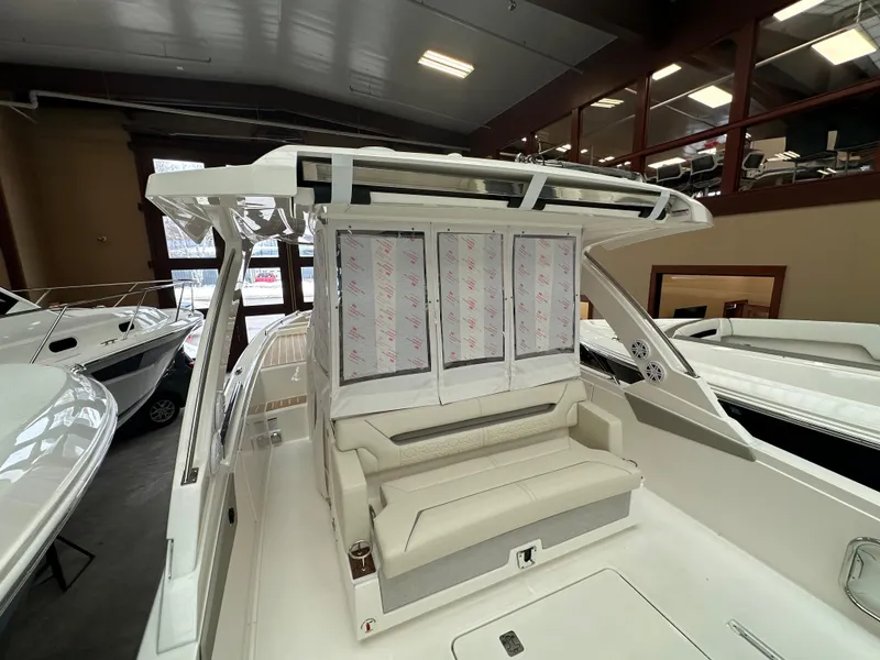 Slide: The Image of 2025 Tiara Yachts 34 LS interior view, showcasing seating and helm area in a showroom. - 5