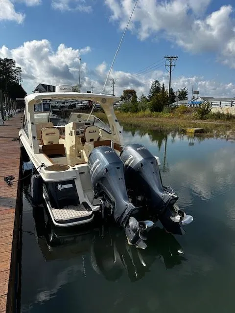 Slide: The Image of 2015 Scout 275 Dorado boat docked with dual outboard motors. - 10