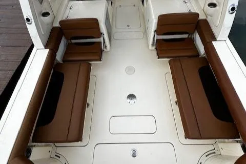 Slide: The Image of 2015 Scout 275 Dorado boat interior with brown seating and white deck. - 12