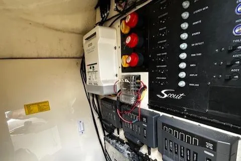 Slide: The Image of Electrical panel of 2015 Scout 275 Dorado boat with control switches and wiring. - 14