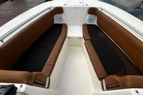 Slide: The Image of 2015 Scout 275 Dorado boat interior with brown seating and speakers. - 15
